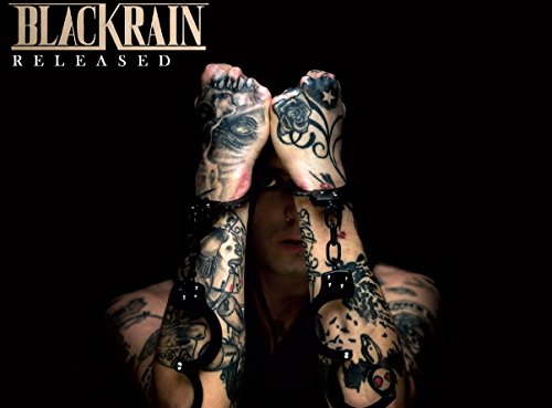 Album cover: man with heavily tattooed arms breaking free from chains against a black background.
