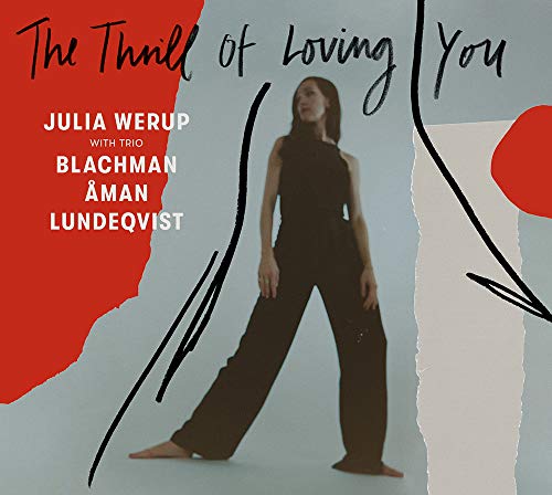 CD album cover with a woman in black outfit on a grey background.
