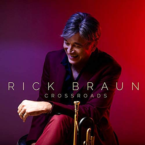"Album cover featuring Rick Braun sitting with a trumpet, against a red and purple background."