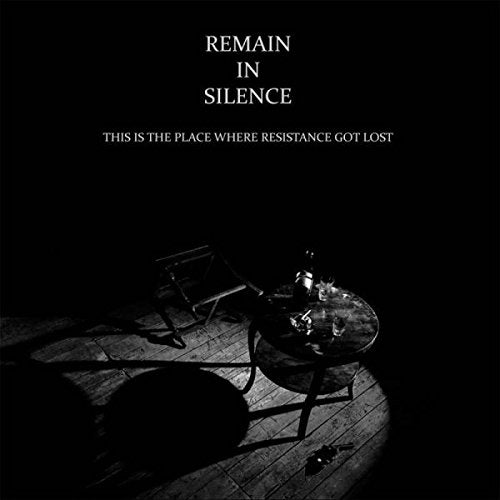 "Black vinyl album cover with a dark room scene and white text."