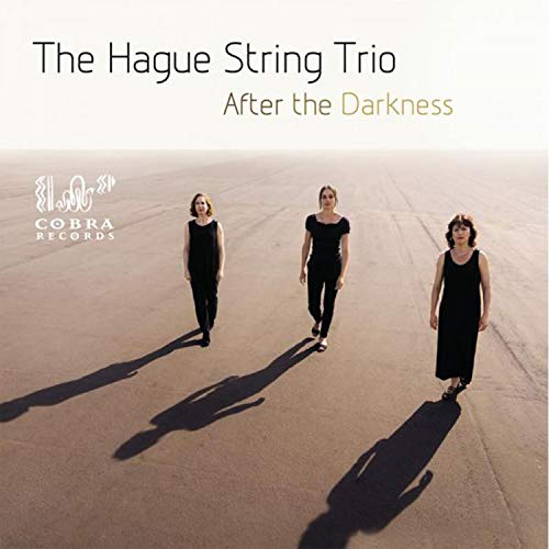 CD cover featuring three women in black walking on a sandy terrain.