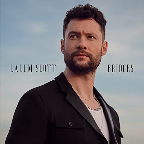 An album cover featuring Calum Scott in a black suit with the title 'Bridges' printed below his name.