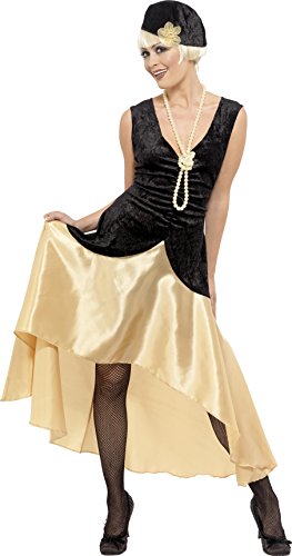 Woman wearing a black and cream 1920s flapper dress, pearl necklace, and headpiece.