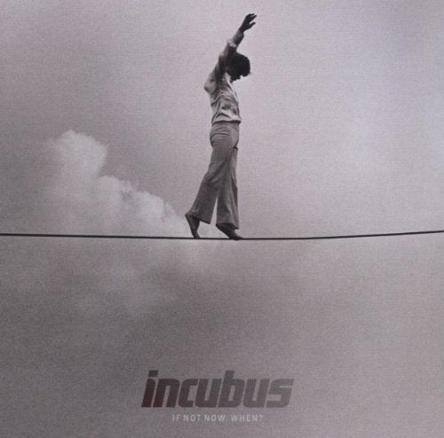 Black and white album cover with man balancing on a tightrope.