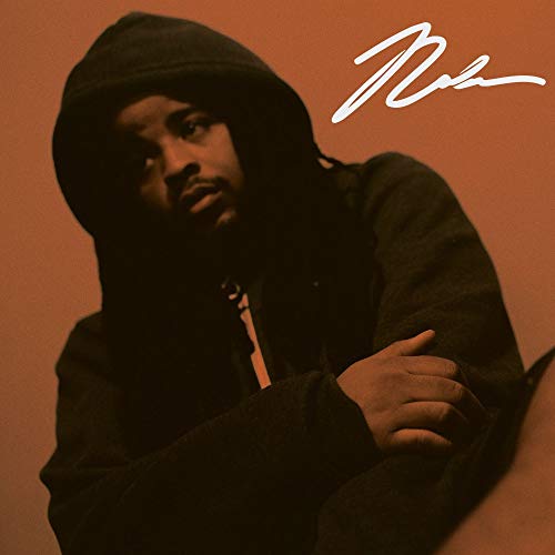 Man in a dark hoodie against an orange background with a white signature.