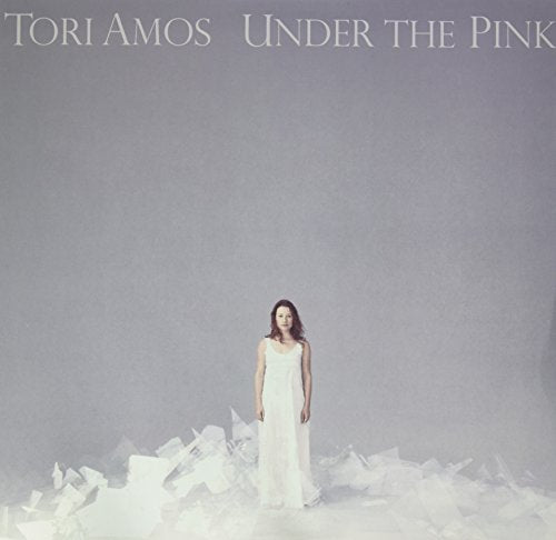 "Tori Amos album cover featuring a woman in white dress amidst crumpled paper."