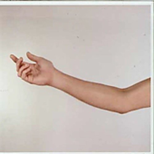 The image depicts a pale arm and hand pointing left against a white background.