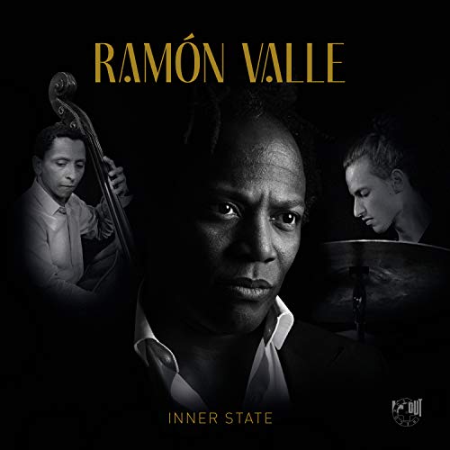 Album cover with three musicians and gold text on a black background.
