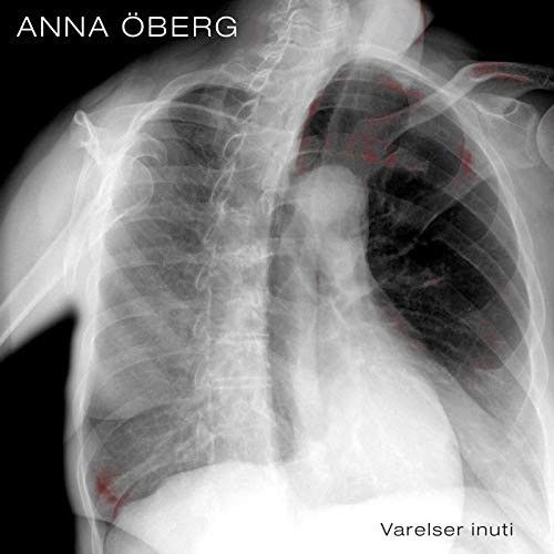 "X-ray image of human chest with red markings, on black background, vinyl album cover."