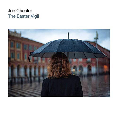 "Album cover: person with umbrella in front of a large building."