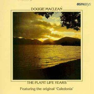 Album cover with serene lake scene at sunset, mountains, and tree branches on pale yellow background.