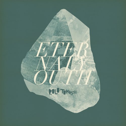 A vinyl record cover with a green background and a large, irregularly shaped stone.