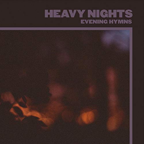 The image depicts a vinyl record cover with a dark, blurry background and text. A concise, descriptive alt text for this image could be: "Dark vinyl record cover with 'Heavy Nights' and 'Evening Hymns' text."