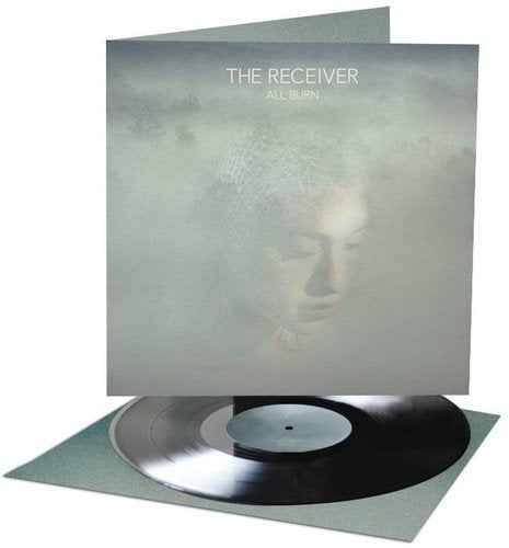 Vinyl record with a grey cover featuring a woman's face in mist.