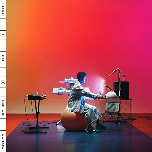 Album cover featuring a man sitting on a beanbag chair surrounded by keyboards and equipment.