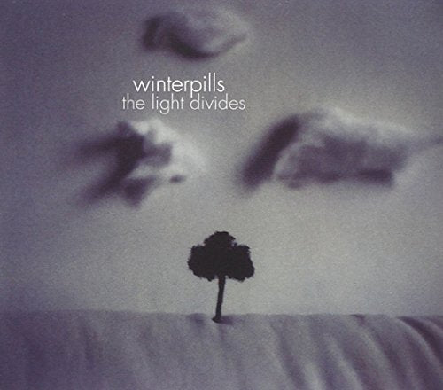 "Album cover featuring a lone tree silhouette against a cloudy, gray-toned landscape."