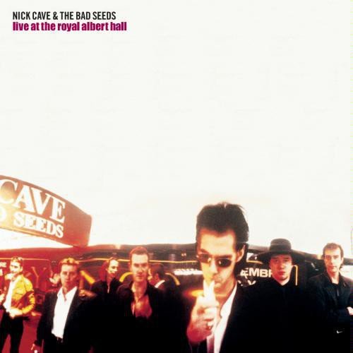 "Album cover with Nick Cave and The Bad Seeds standing outside, in suits, under red lighting."