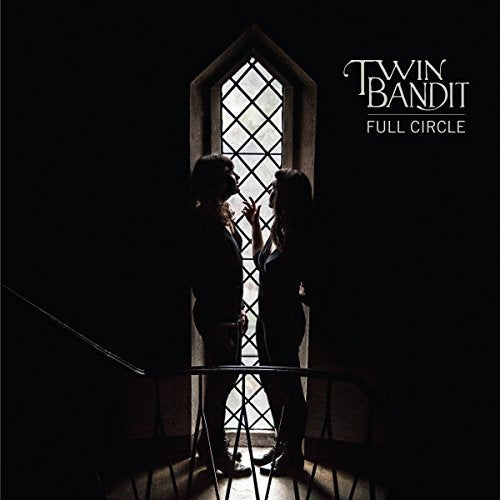 "Album cover with silhouetted figures facing each other, lit by a window behind."