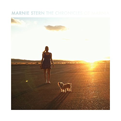 Album cover: woman in dress walks dog on road at sunset, with mountains in background.