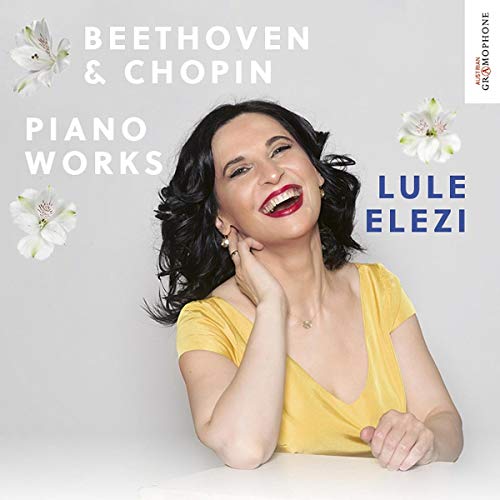 A smiling woman in a yellow top on a CD cover with white flowers.