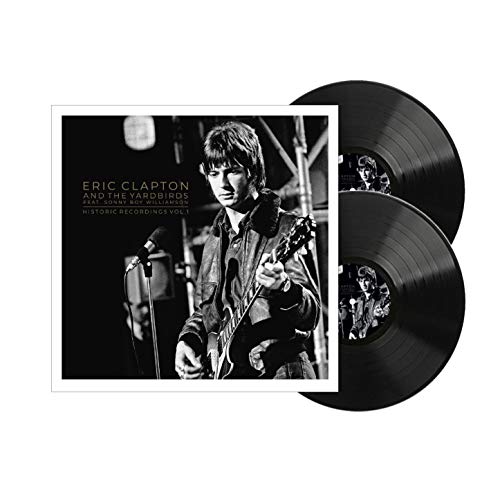 "Black vinyl records with album cover featuring Eric Clapton playing guitar on stage."