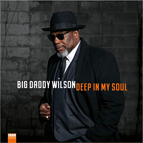 Big Daddy Wilson in suit and hat, album cover against brick wall.