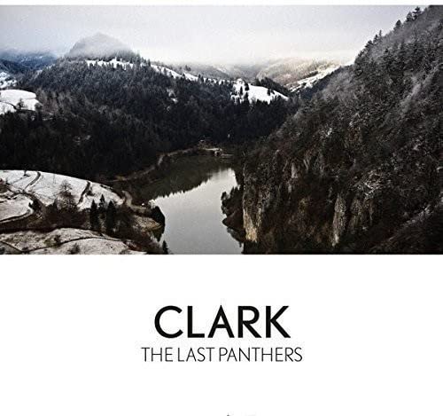 Vinyl record cover: snowy mountains reflected in a dark lake, text "Clark - The Last Panthers".