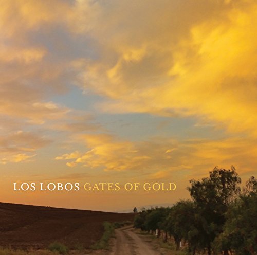 "Album cover with dirt road, trees, and sunset, titled 'Los Lobos Gates of Gold'."