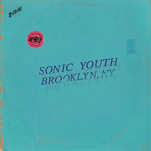 Teal CD cover for Sonic Youth’s “Live In Brooklyn 2011” with red eye sticker.