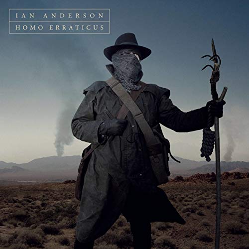 "Album cover featuring a man in a desert, wearing a hat and holding a staff."