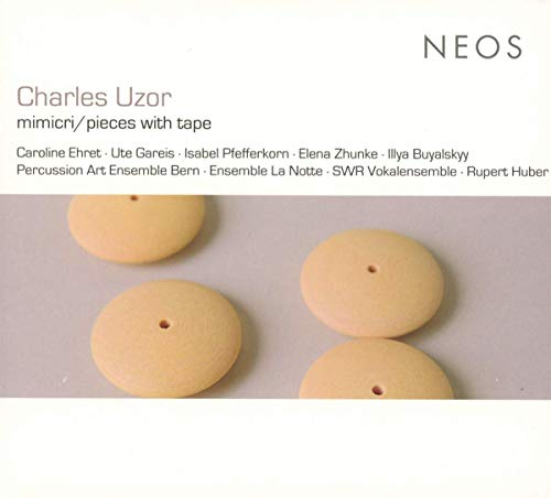 The image shows a CD cover with four beige buttons on a gray surface.