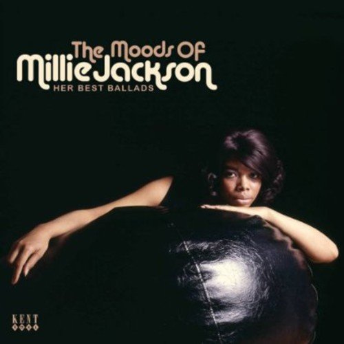 "CD cover featuring Millie Jackson sitting against a brick wall, wearing red shirt and jeans."