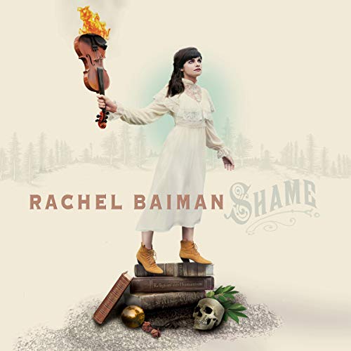 "Woman in white dress holding flaming violin, standing on books with skull and objects."