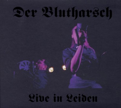 "CD cover with a man holding a microphone, gothic text, dark background."