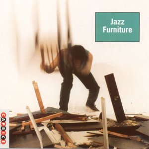 Blurry image of a person surrounded by broken furniture with "Jazz Furniture" text overlay.