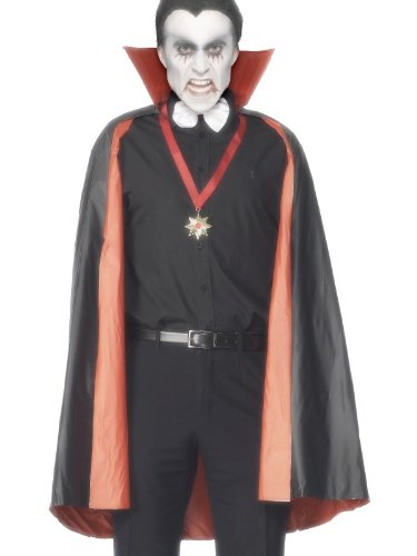 The image shows a man dressed as a vampire. Alt text: Man in a black vampire costume with red-lined cape against a white background.