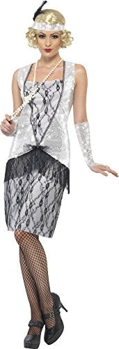 Woman wearing a silver and black flapper costume, fishnet stockings, and pearl accessories.