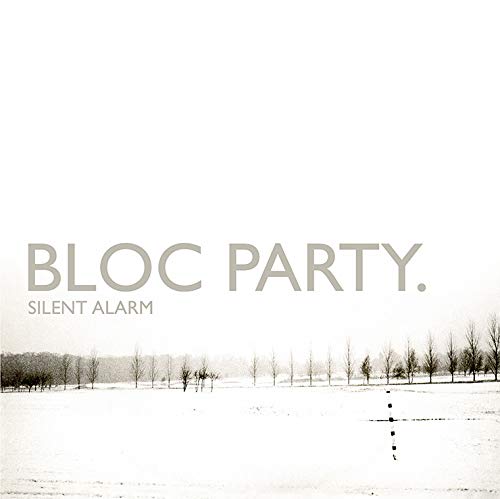 "Album cover for Bloc Party's 'Silent Alarm' featuring a snowy landscape with bare trees."