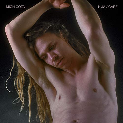 A shirtless man with long hair on a black album cover.