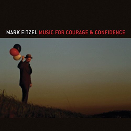 "Album cover with man juggling on a hill at dusk, with title text above."