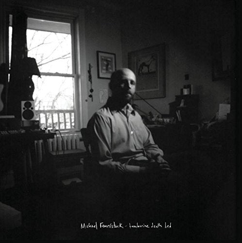 Black and white album cover featuring a man sitting in a dimly lit room.