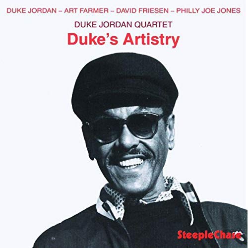 "Black and white image of a man wearing sunglasses and a hat on a vinyl album cover."