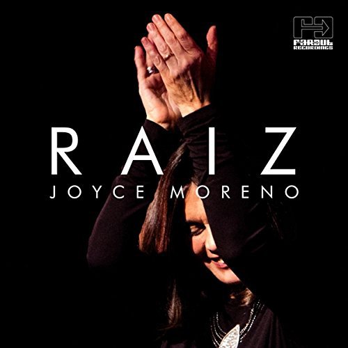 Album cover with a woman's face and hands raised, against a black background.