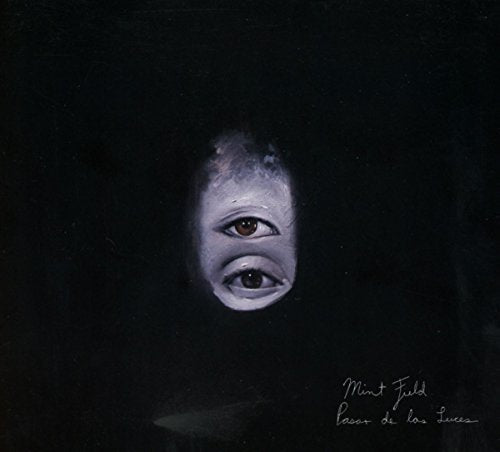 "Album cover with a child's face partially visible in darkness, eyes staring forward."