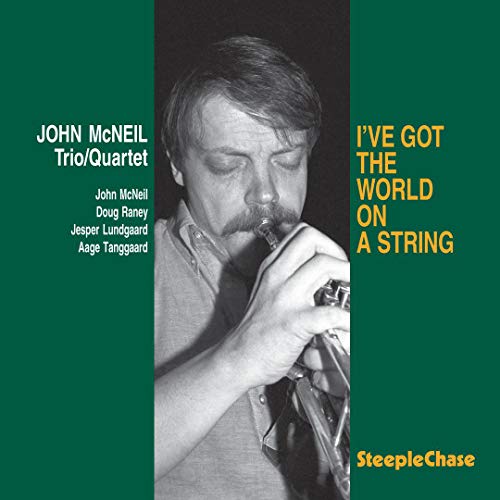 "Album cover with a man playing a trumpet, green background, white and yellow text."