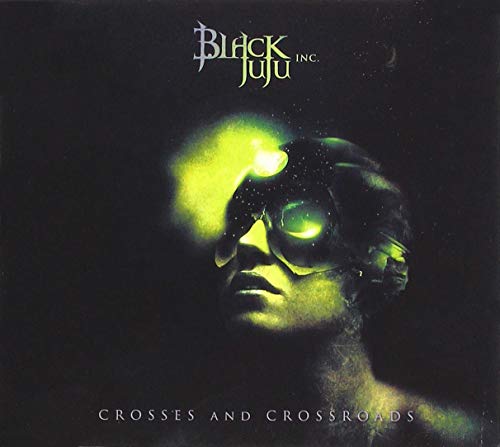 "Album cover with a man's face and glowing green eyes on a black background."