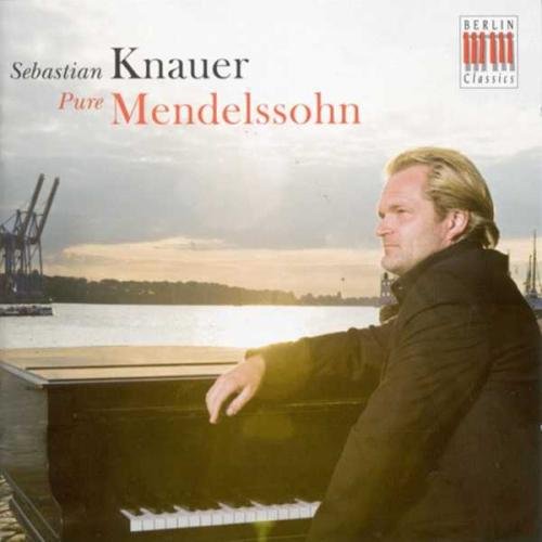 A man with blond hair plays piano on a CD cover.
