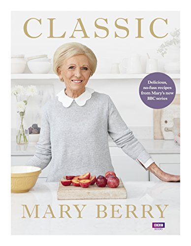 "Cookbook cover featuring Mary Berry in a kitchen with a cutting board and fruit."