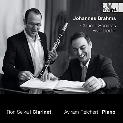 Black and white image of two men in suits playing clarinet and piano together.