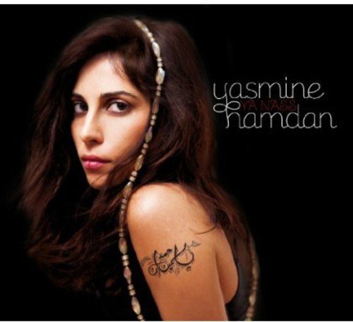 "Album cover featuring a woman with long dark hair and a tattoo on her arm."